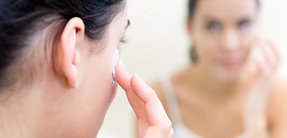 woman applying cream