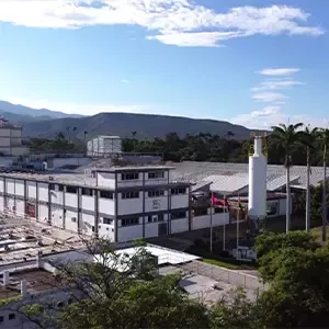 Nestlé El Tocuyo factory with white production buildings and a silo set against green hills